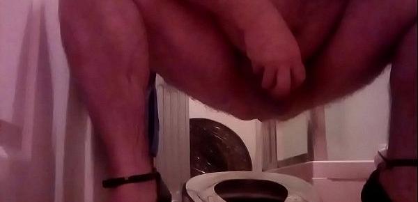  Frontal view of me on the potty  bedpan squirting out enema,in high heels